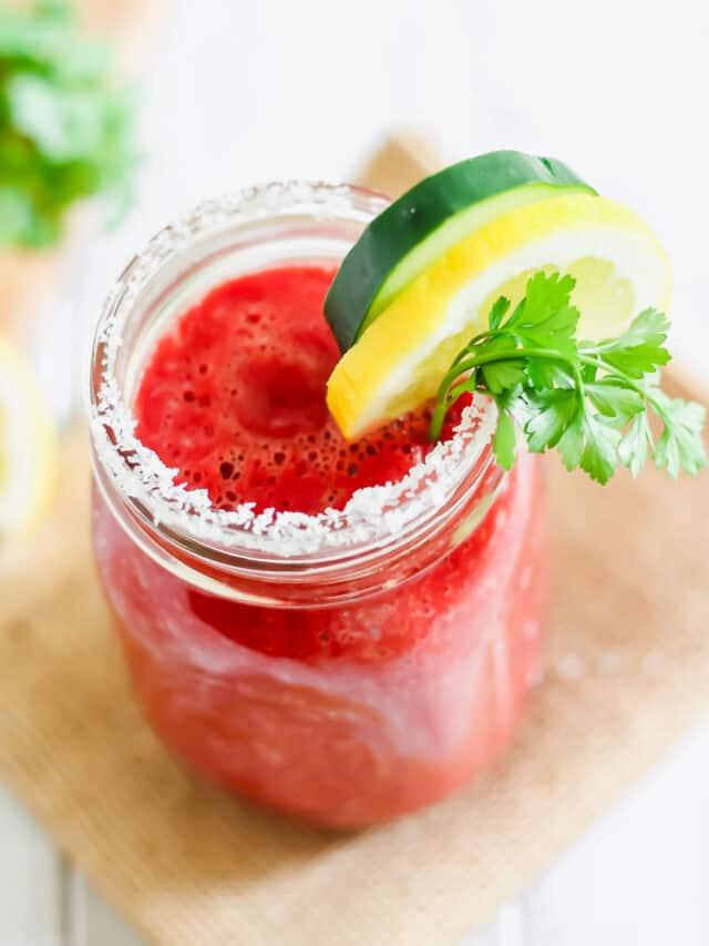 A mason jar with a v8 drink and garnishes.
