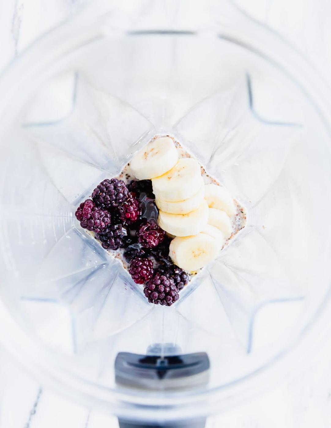 A blender filled with berries and bananas.