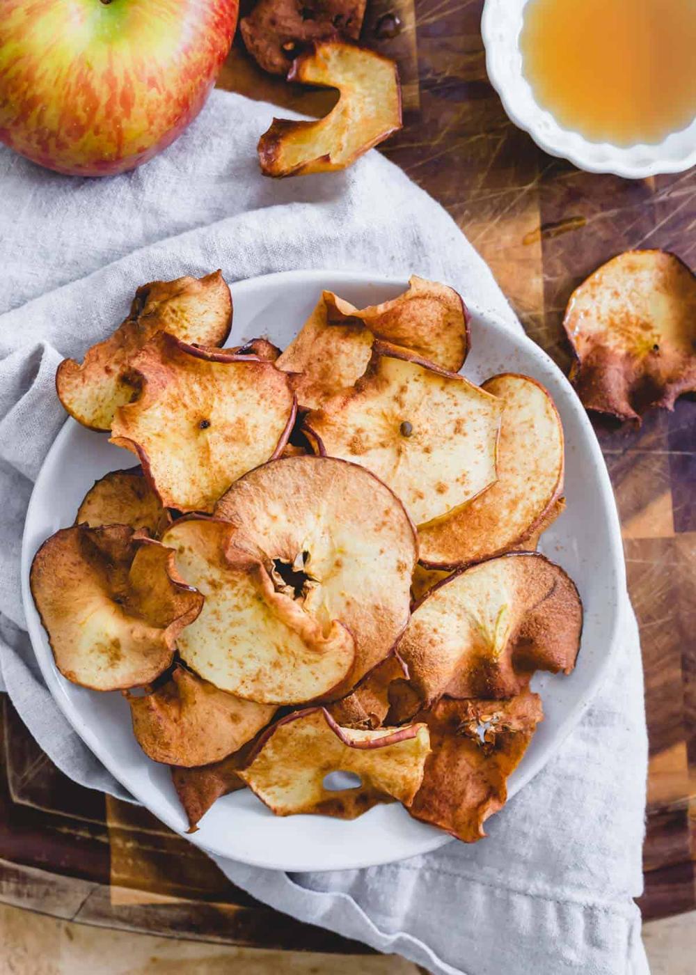 Air fryer apple chips with maple syrup and cinnamon.