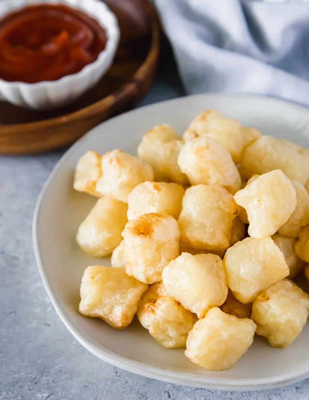 Crispy air fried cauliflower gnocchi can be eaten as an appetizer dipped in your favorite condiment like ketchup.