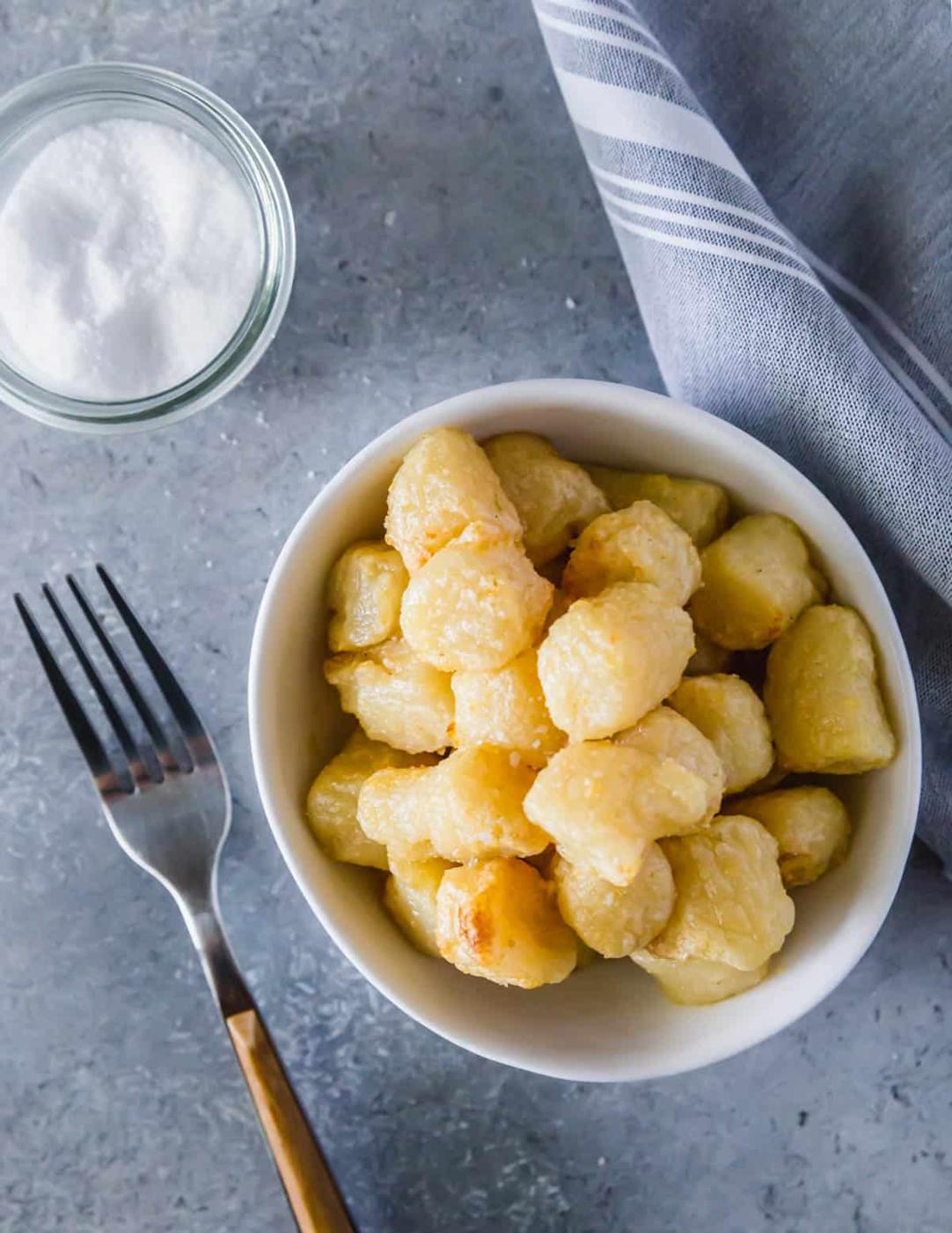 Simple air fried cauliflower gnocchi tossed with olive oil, garlic powder and salt is an easy and delicious meal ready in just 20 minutes.