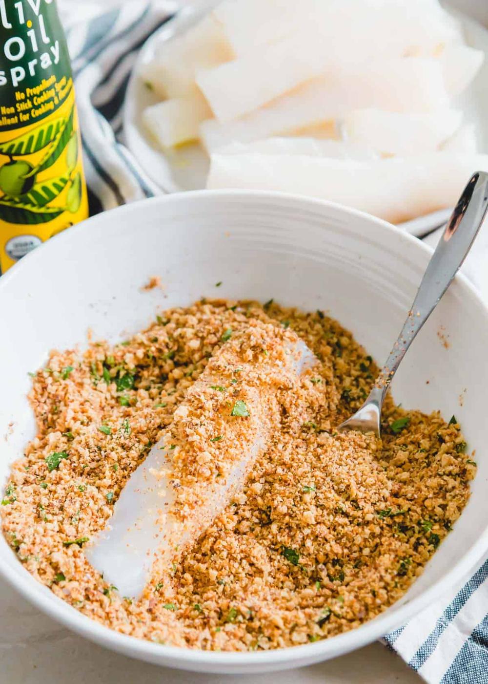 Gluten-free breadcrumbs, ground flax seed, salt, pepper and fresh parsley coat fresh pieces of wild caught cod for this easy air fryer fish stick recipe.