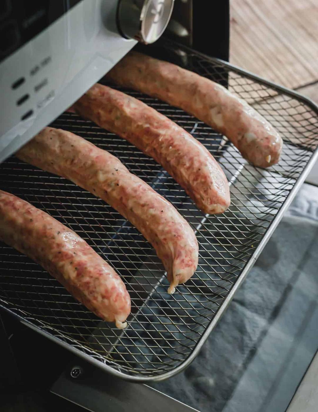 Sausage links on a tray in air fryer before cooking.