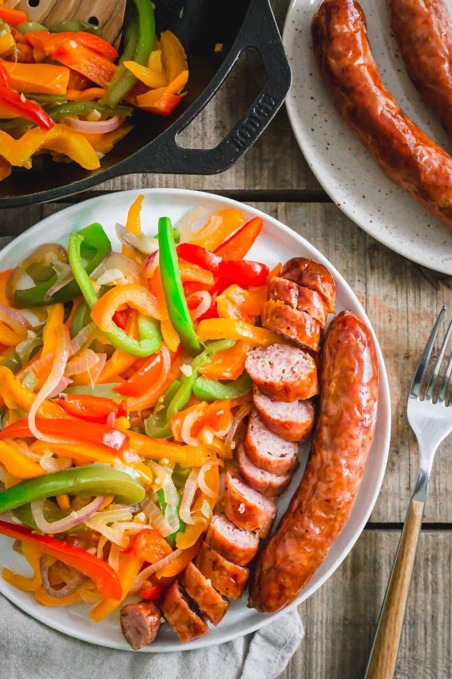 Sausage cooked in the air fryer served with peppers, onions and garlic.