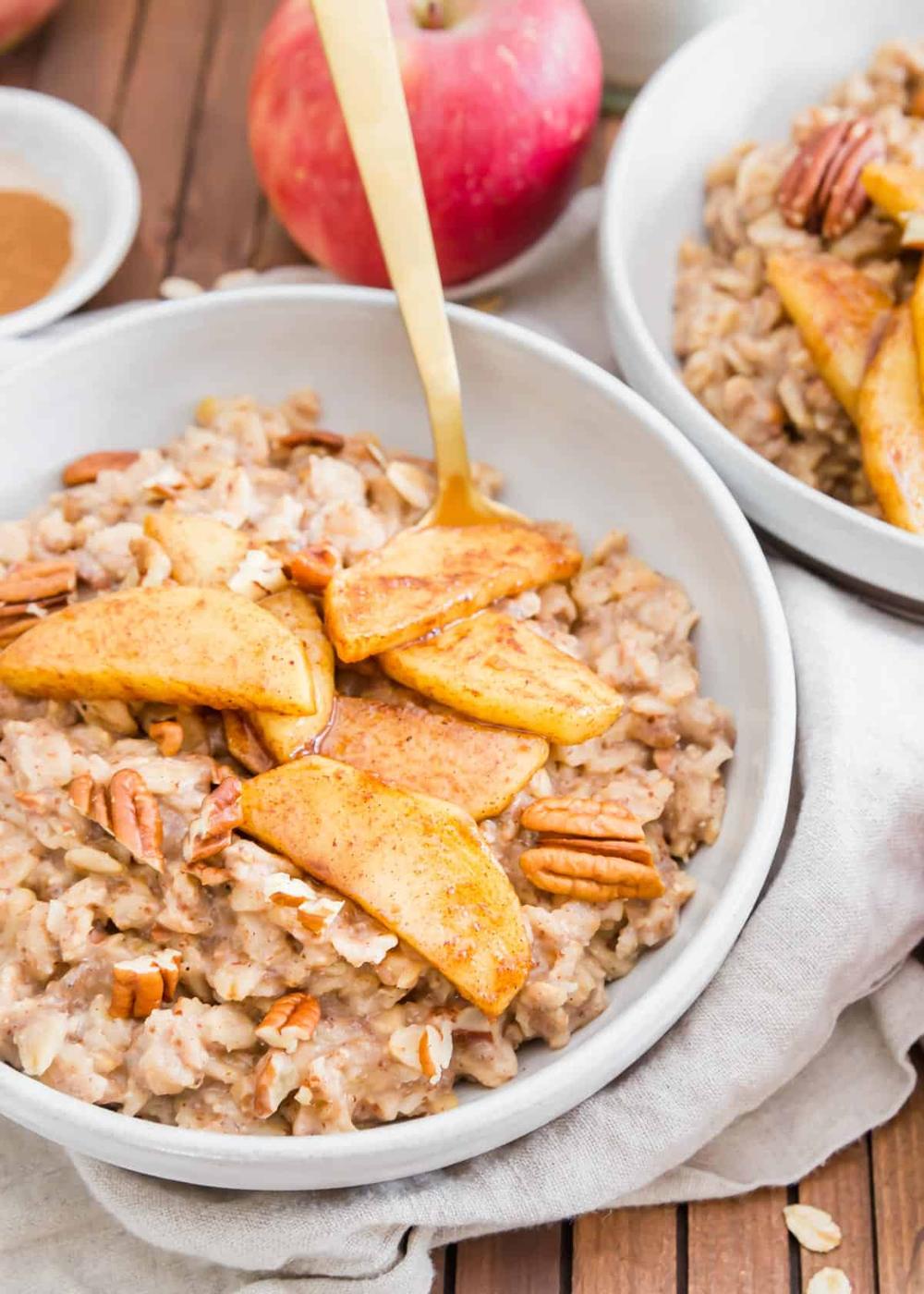Easy stovetop apple cinnamon oatmeal with chopped pecans and maple syrup cooked apple slices.