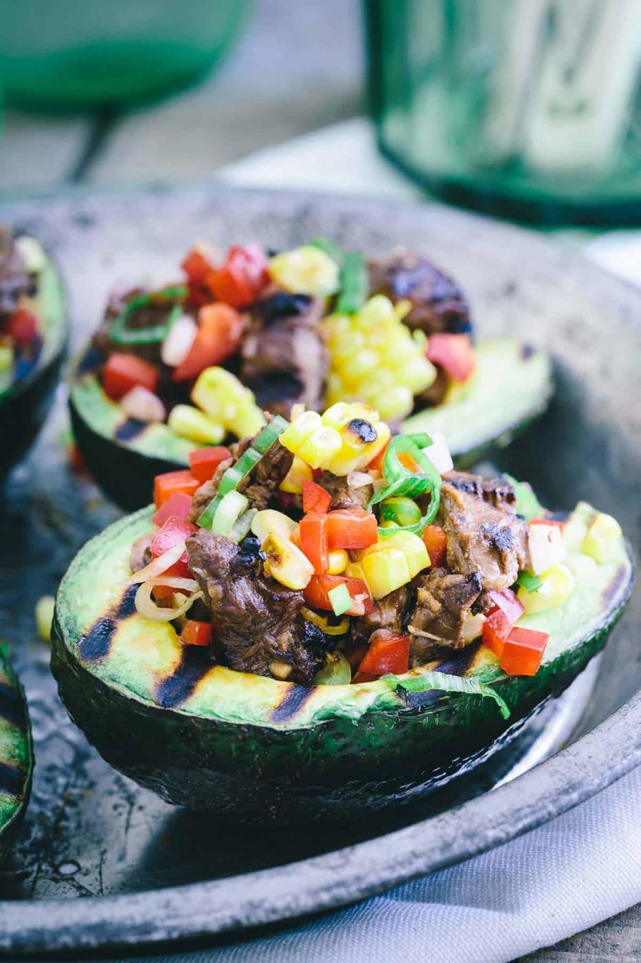 Grilled Avocados make the perfect vessel for stuffing with grilled steak, corn, peppers and scallions for a delicious summer meal.