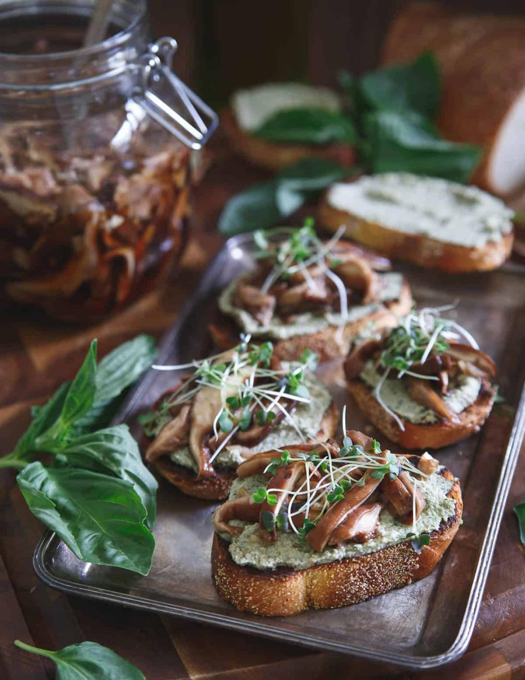 These shiitake crostini have been pickled in balsamic vinegar and paired with a creamy basil pesto ricotta spread for the perfect toasty bite.