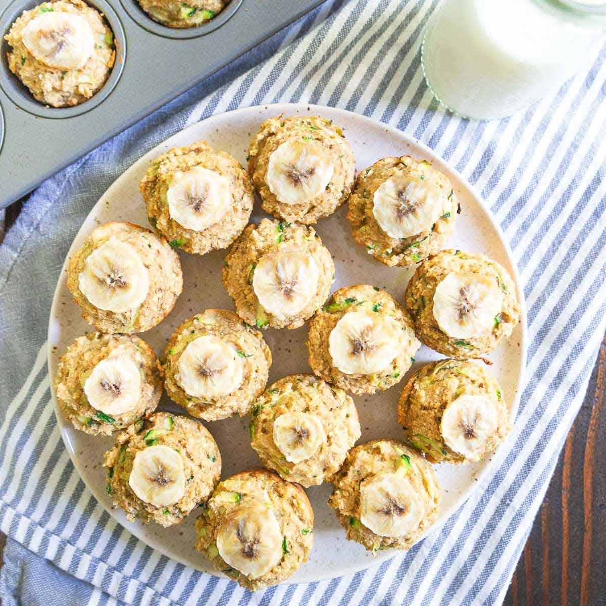 This banana zucchini muffin recipe is super simple and makes a batch of 20 mini-muffins for snacking all week long.