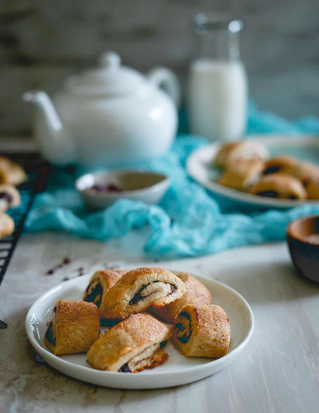 Apple butter rugelach on a white plate.
