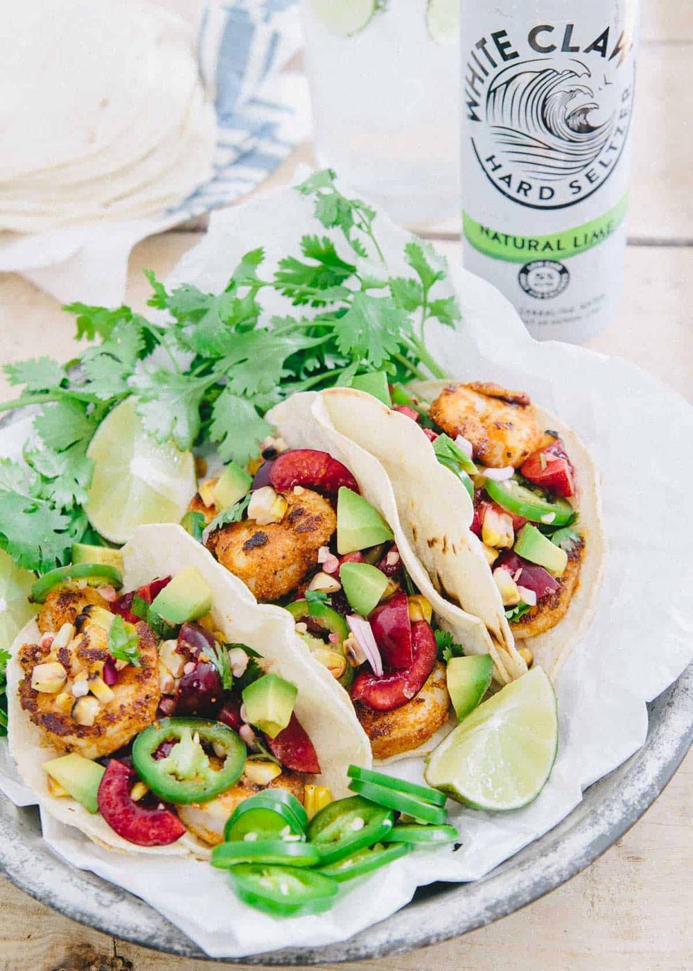With a simple salsa full of juicy cherries, grilled corn and spicy jalapeños, these blackened shrimp tacos are a great summer meal.