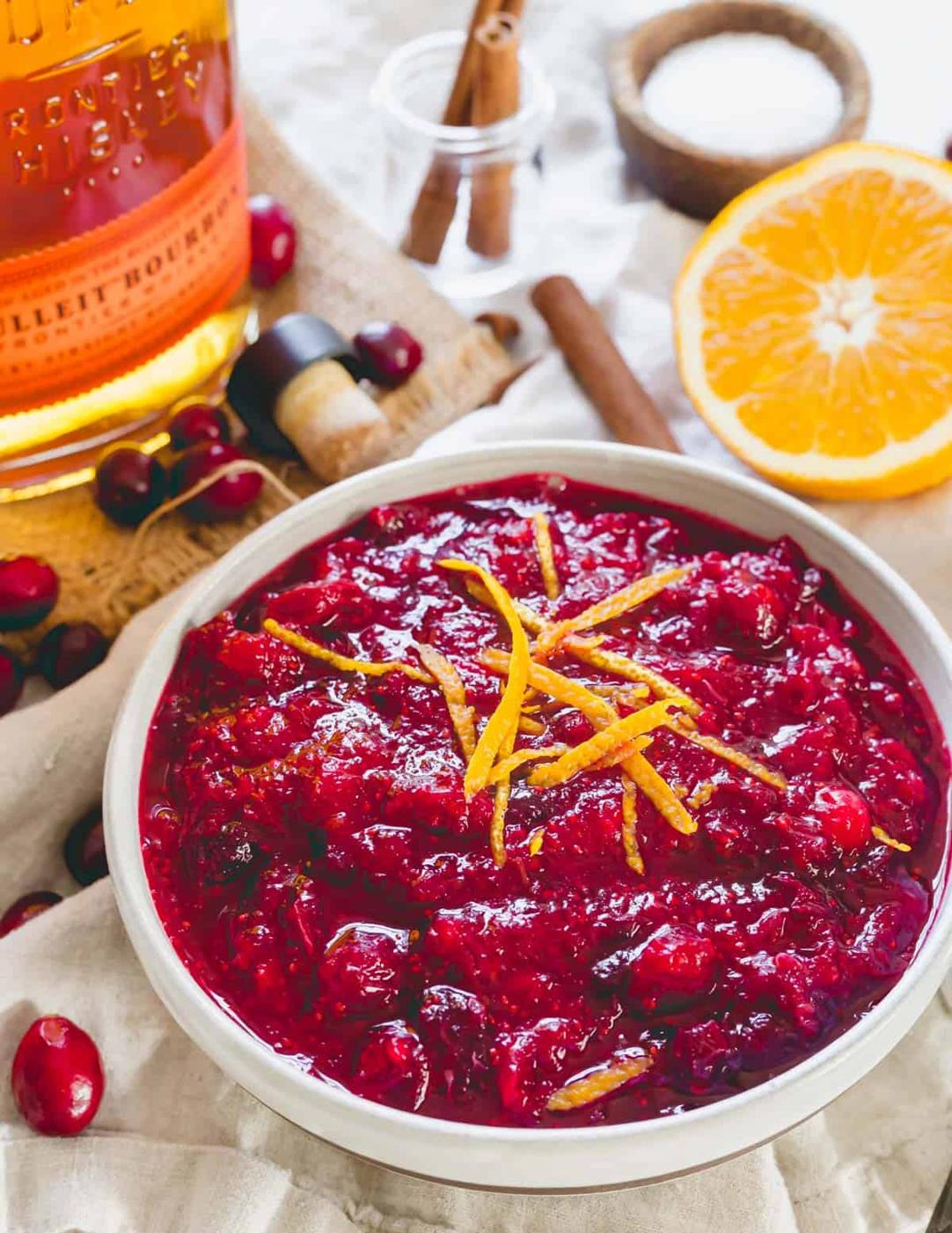 Bourbon cranberry sauce in a bowl with orange zest.