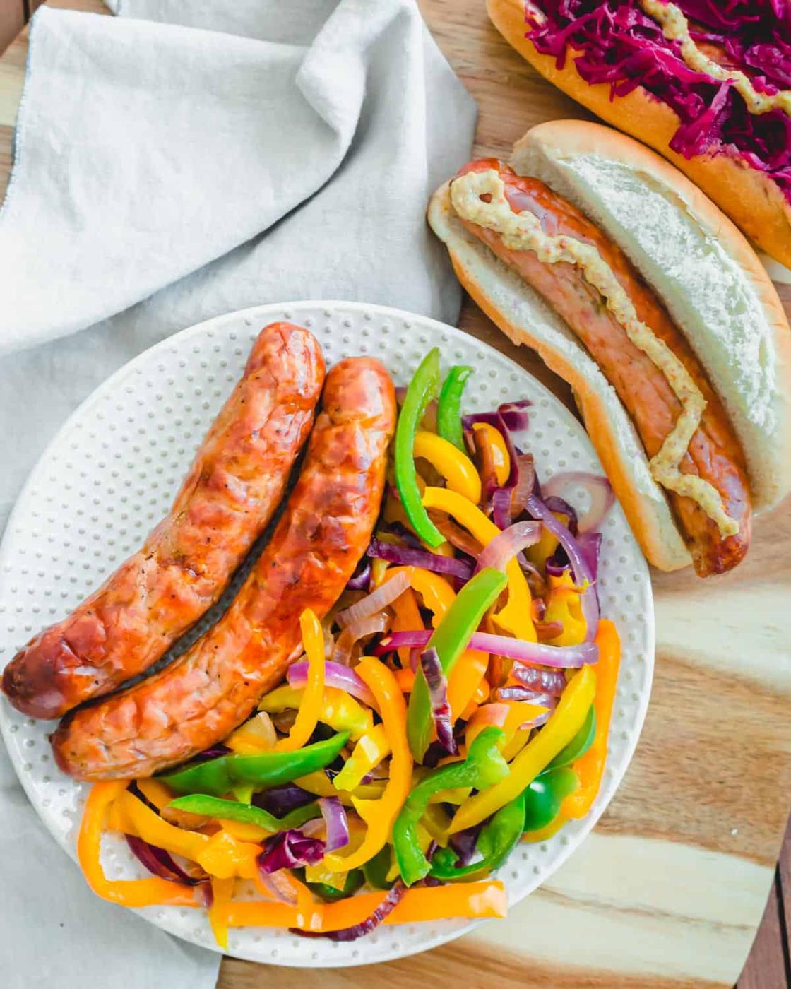Serve air fried brats with sautéed peppers and onions.