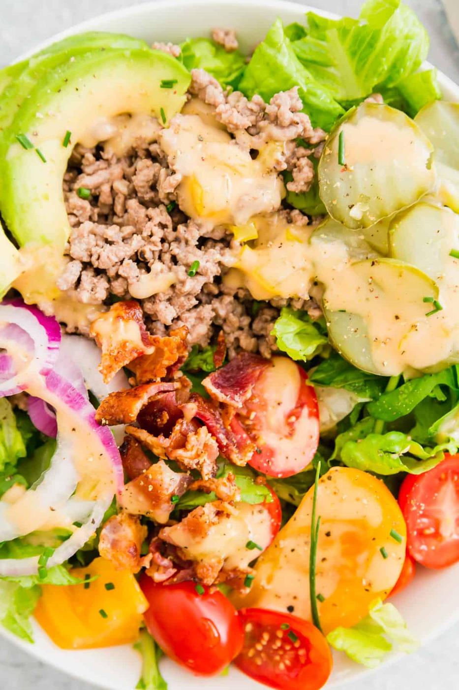 Seasoned ground beef, pickles, tomatoes, red onion, bacon and avocado slices topped with a creamy burger sauce make these burger bowls irresistible!