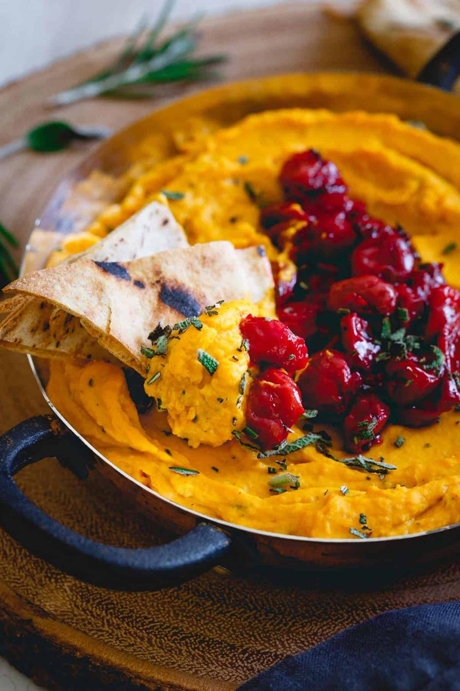 Creamy butternut squash dip is topped with a simple tart cherry compote for a festive appetizer.