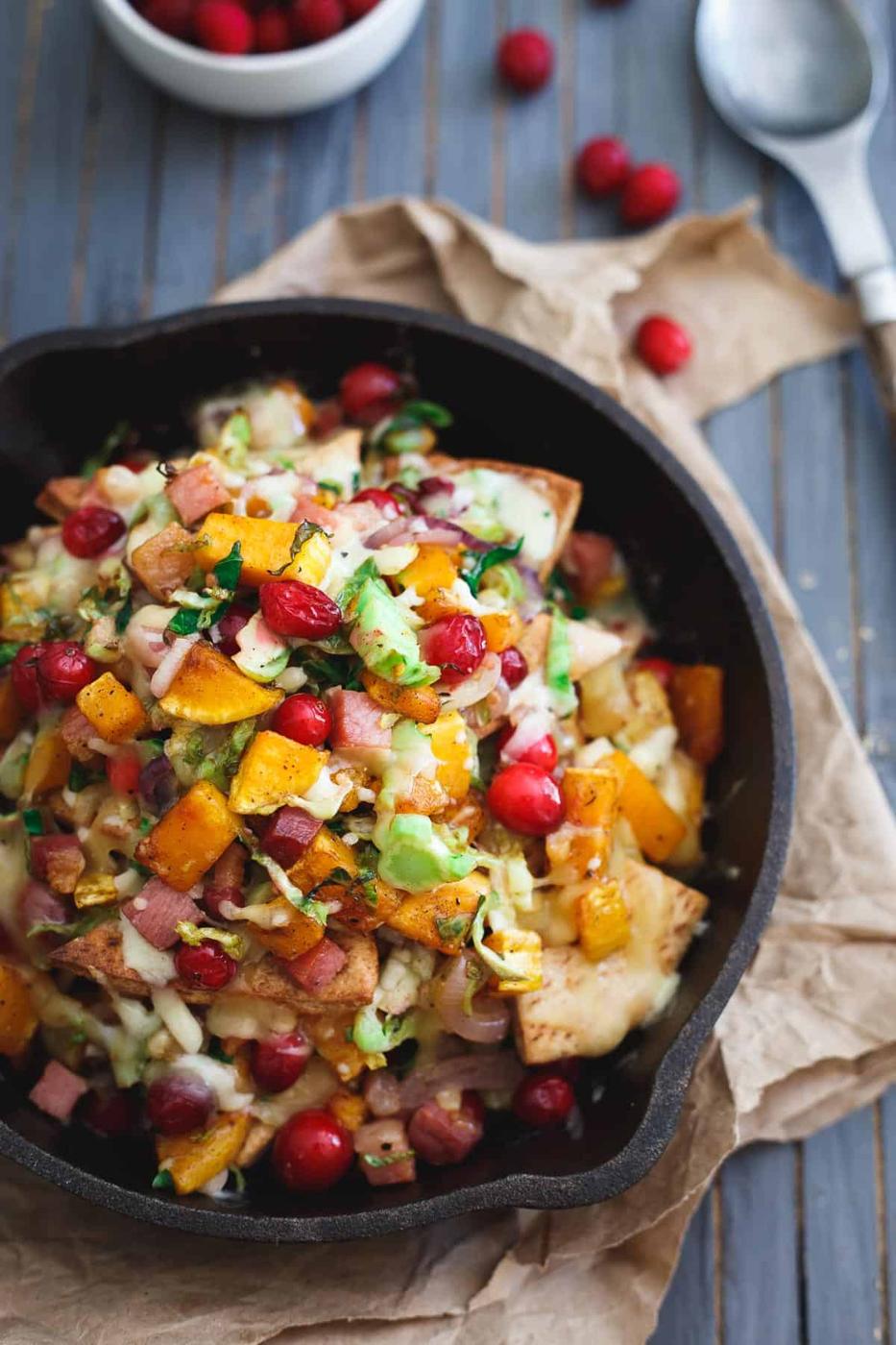 These butternut squash pita nachos bring a fall twist to the table packed with brussels sprouts, cranberries, pancetta and caramelized onions.