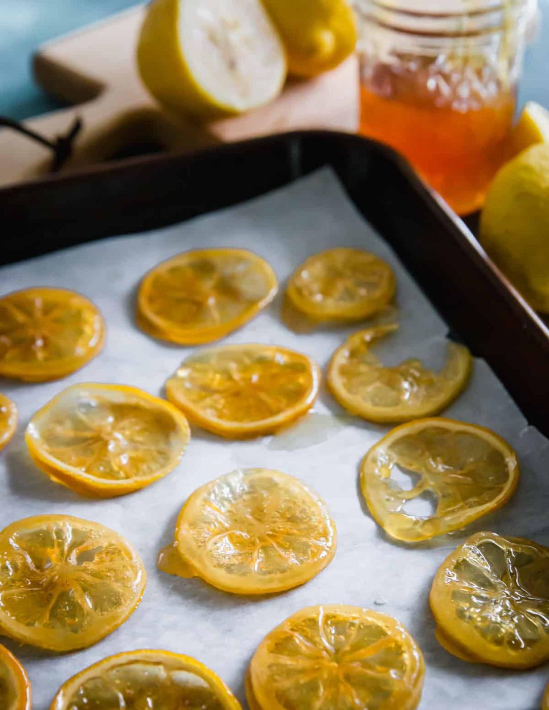 Candied lemon slices drying on a sheet pan