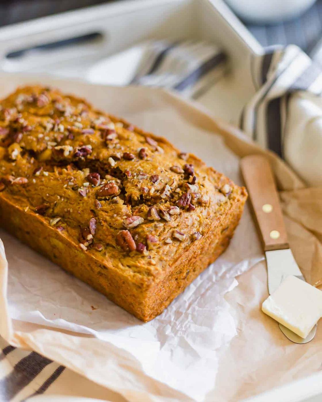 Carrot bread recipe with a pat of butter on the side.