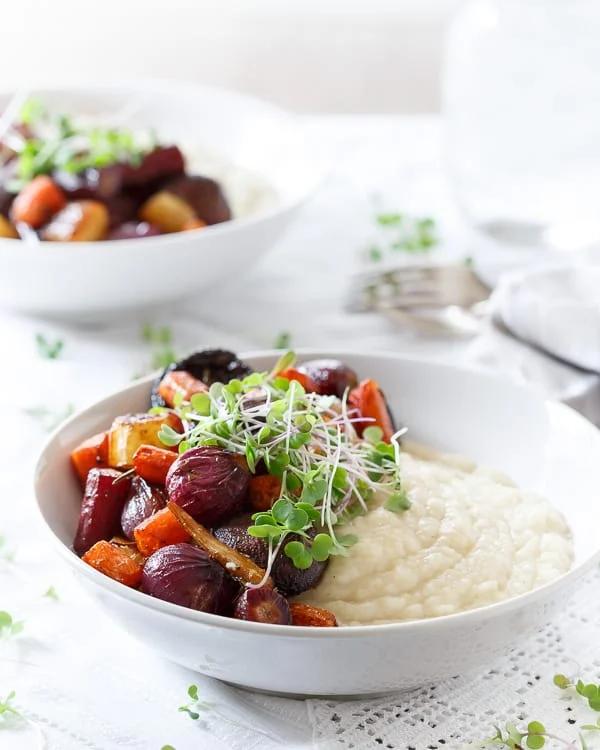 Sweet balsamic coated rainbow carrots, pearl onions and mushrooms are roasted until tender and served on top of a creamy celery root puree.