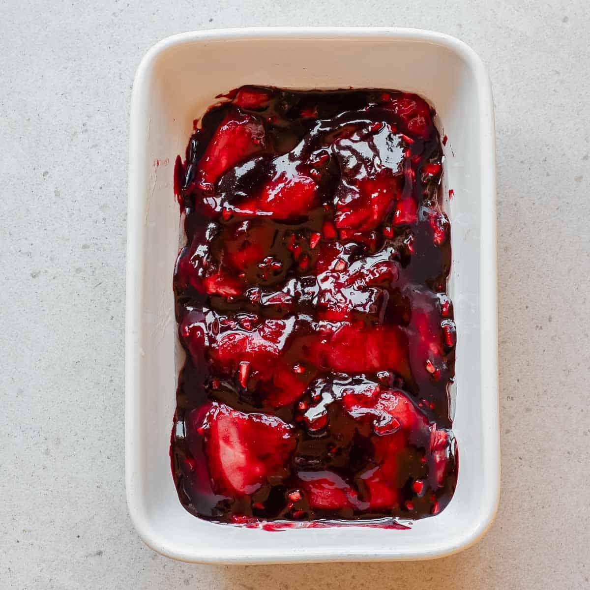 A white rectangular dish filled with marinating char siu chicken.