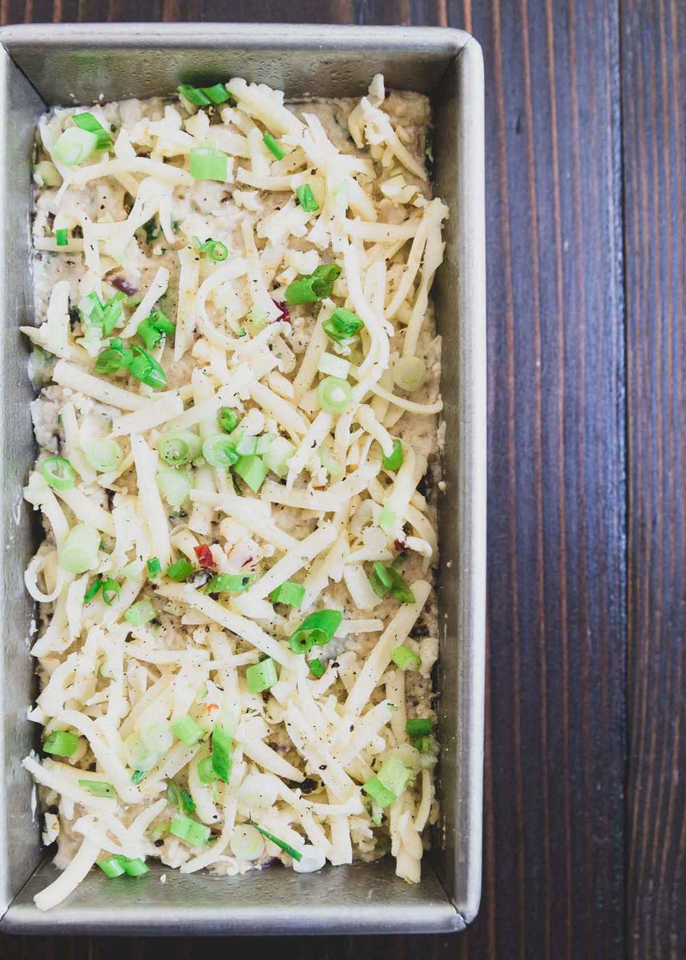 Cheese filled zucchini bread topped with green onions.