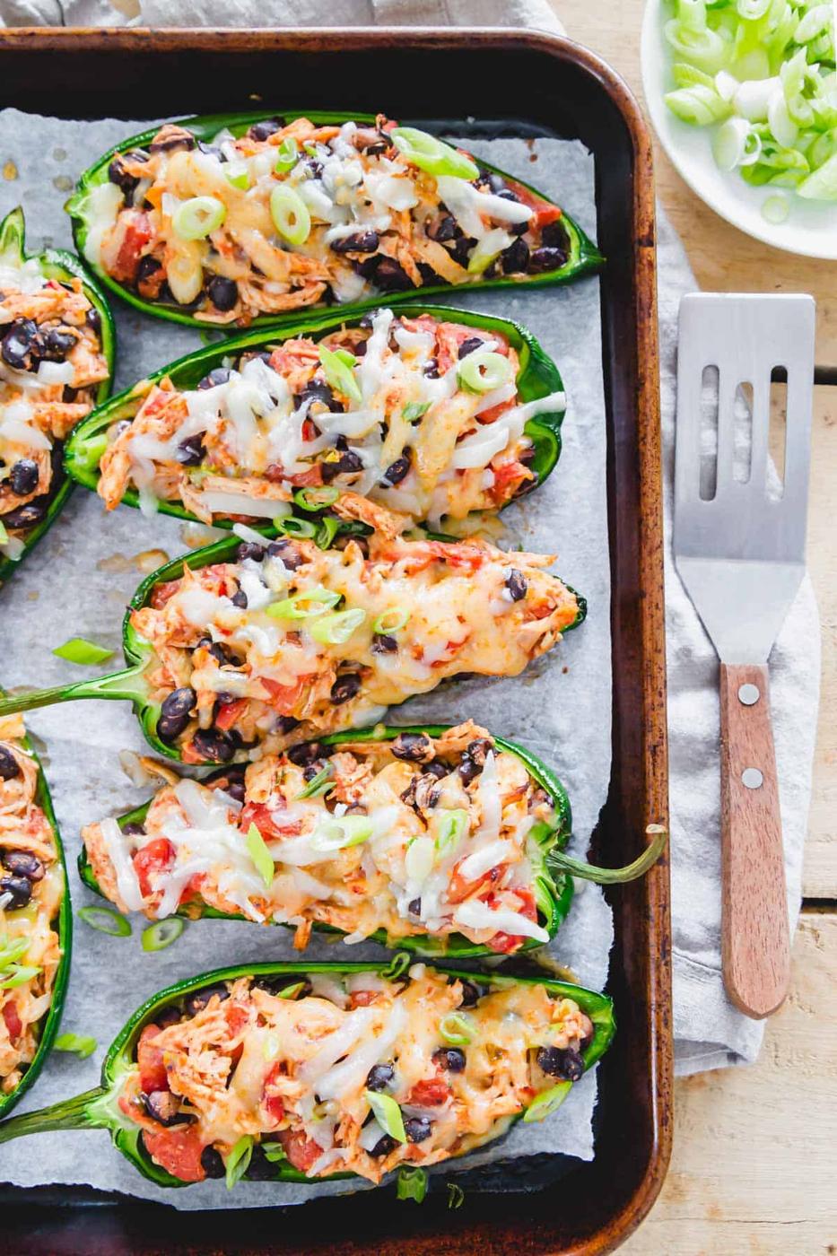Spicy stuffed Mexican poblano peppers with chicken, black beans, tomatoes and lots of melted cheese are an easy weeknight meal everyone will love!