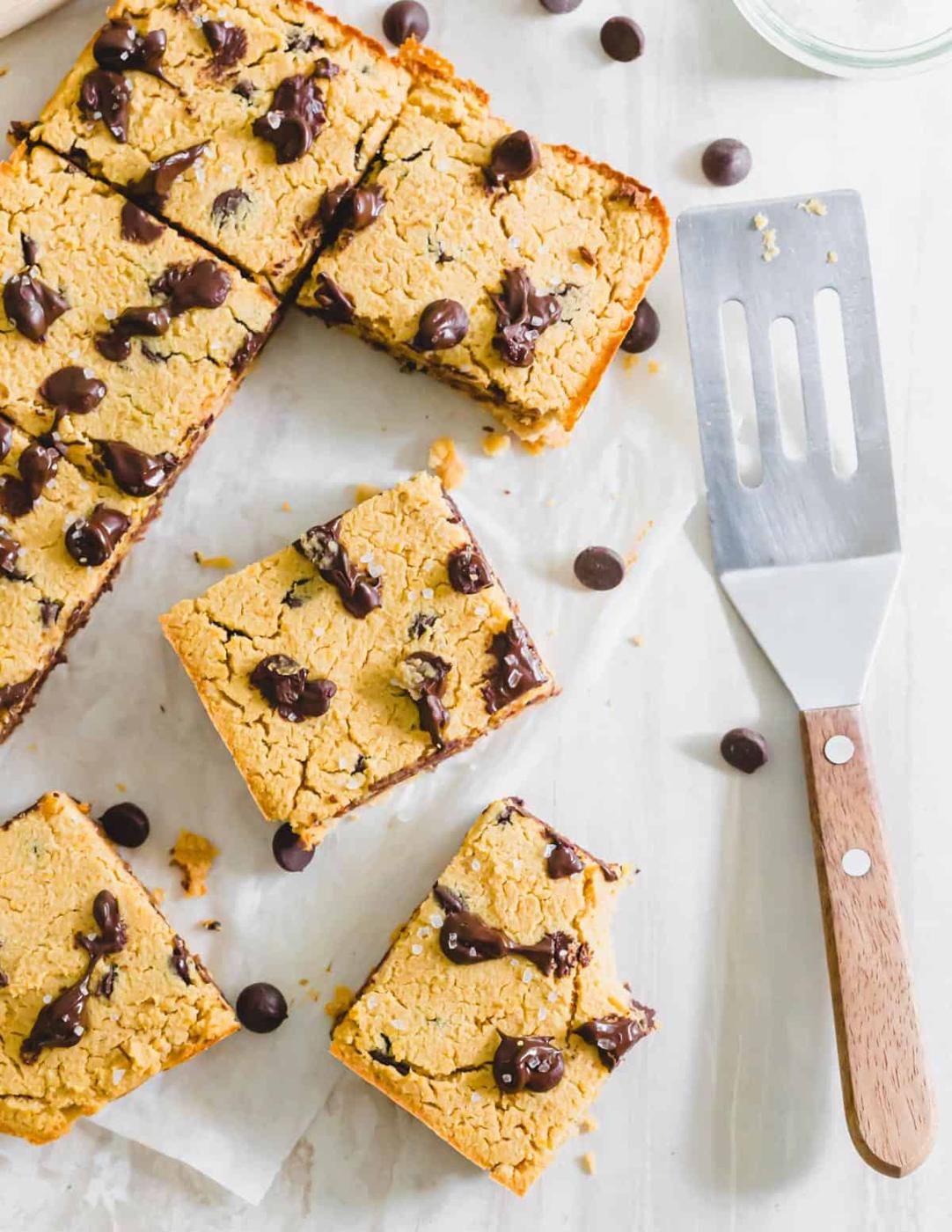 Naturally vegan and gluten-free chickpea blondie recipe with chocolate chips cut into bars and garnished with coarse sea salt.