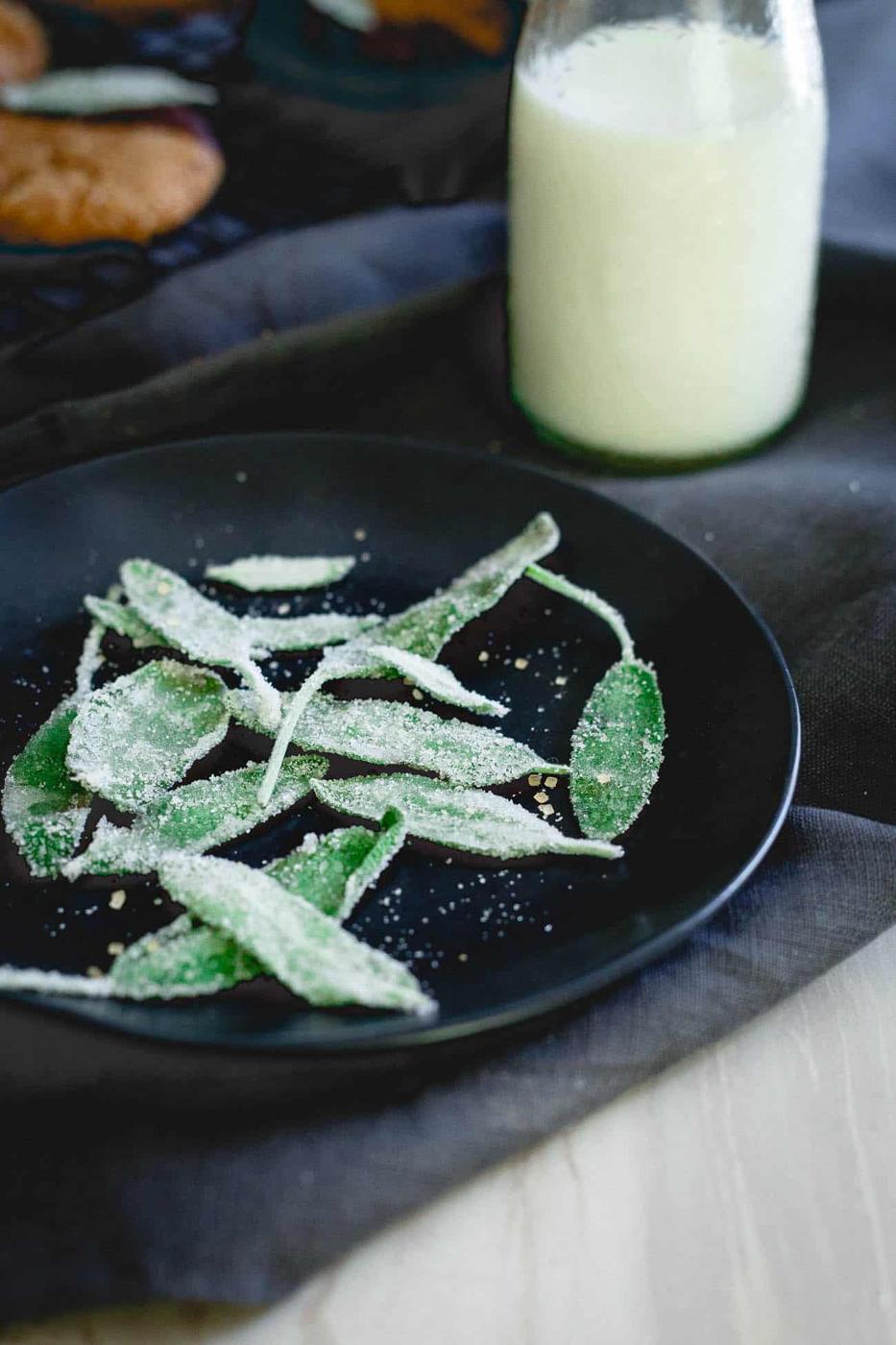 Candied sage garnishes these chocolate dipped cashew almond butter cookies for a festive twist!