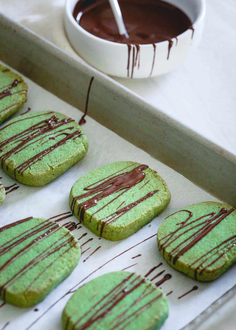 These chocolate drizzled matcha shortbread cookies are gluten-free, buttery, crispy and perfect for dunking in that cozy holiday cup of coffee or tea.