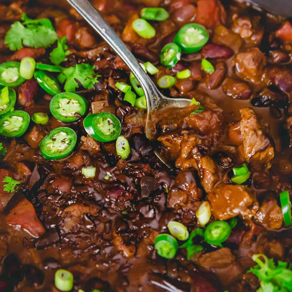 Bittersweet chocolate and cocoa powder add a fun twist to chili in this chocolate lamb chili recipe with a Mexican mole vibe.