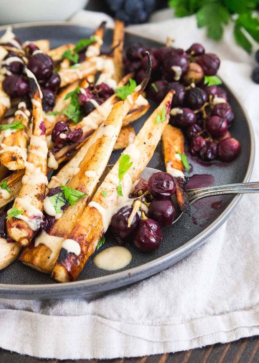 These sweet roasted parsnips and grapes make a show stopping side dish for any winter holiday meal.
