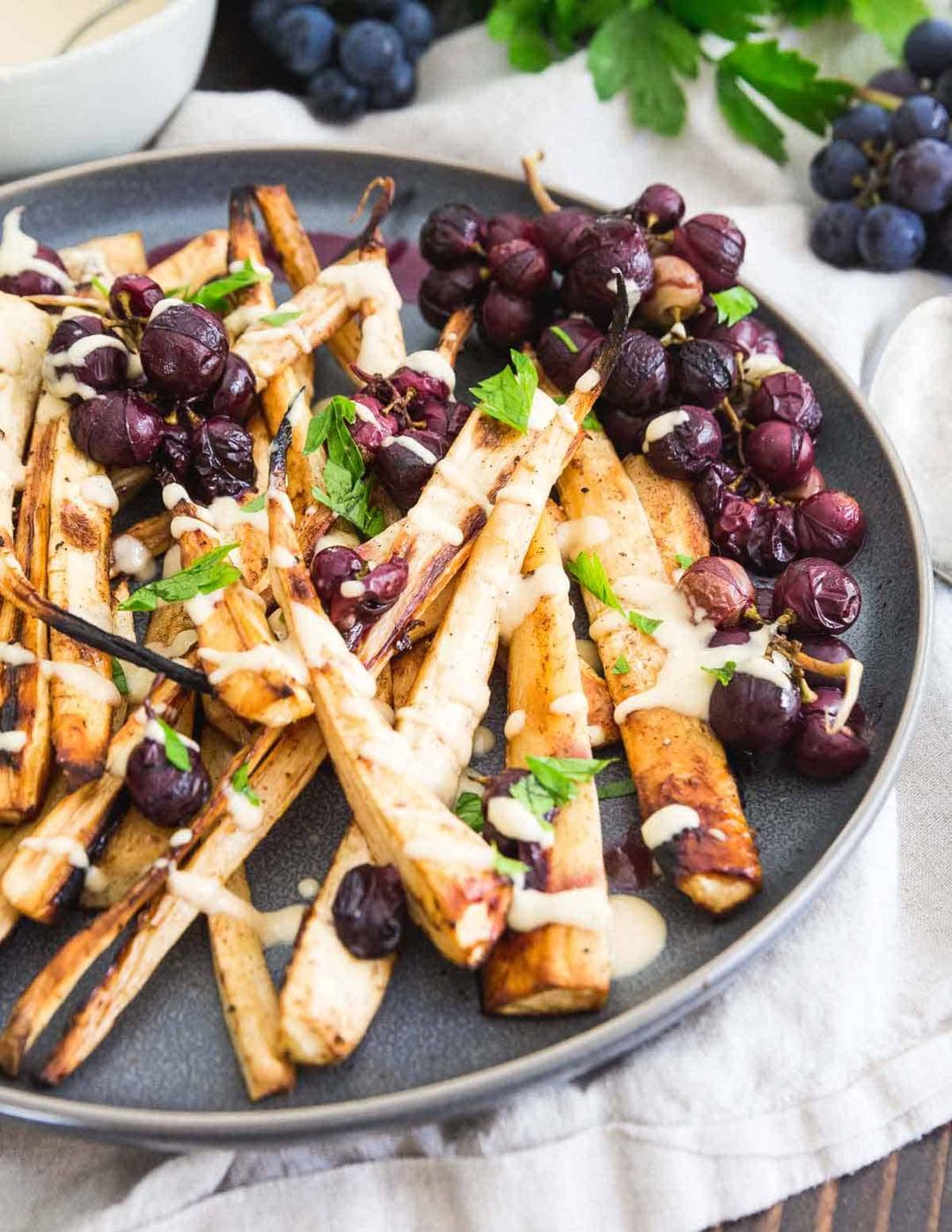 Roasting parsnips and concord grapes with cinnamon and brown sugar totally transform this side dish into something special and unique. Try it for your holiday dinner!
