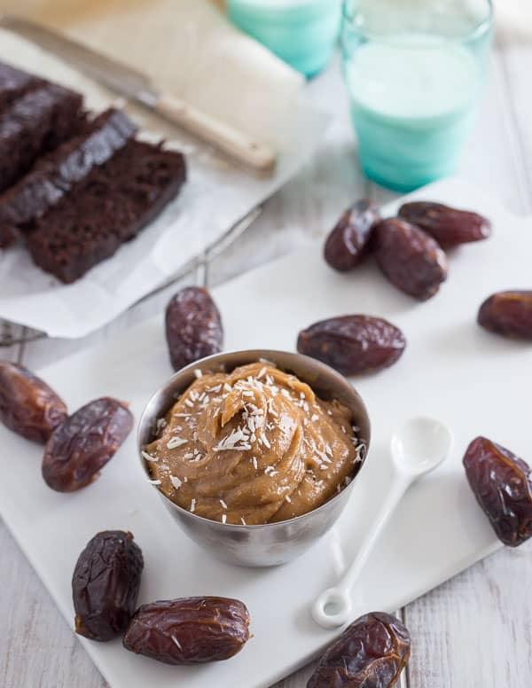 Coconut Date Spread in a small ramekin next to medjool dates.