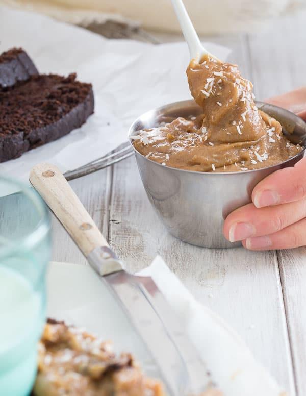 Stirring the date spread in a small stainless steel bowl.