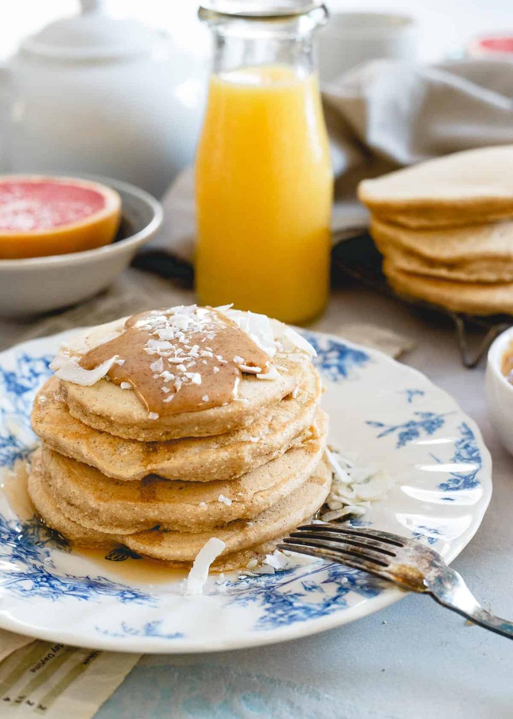 Doughy coconut flour pancakes with a coconut almond butter sauce are a simply delicious way to enjoy a pancake breakfast.