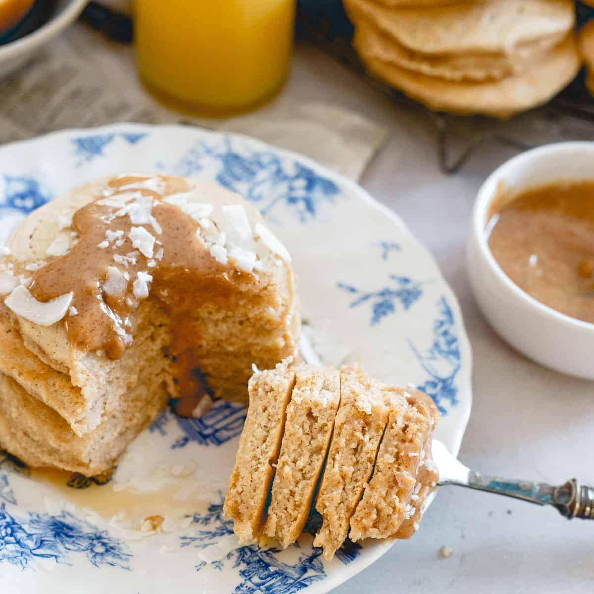 Topped with a creamy coconut almond butter sauce, these coconut flour pancakes are a delicious start to the day.