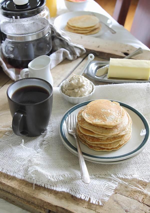 Coconut ricotta pancakes with caramelized banana creme fraiche butter