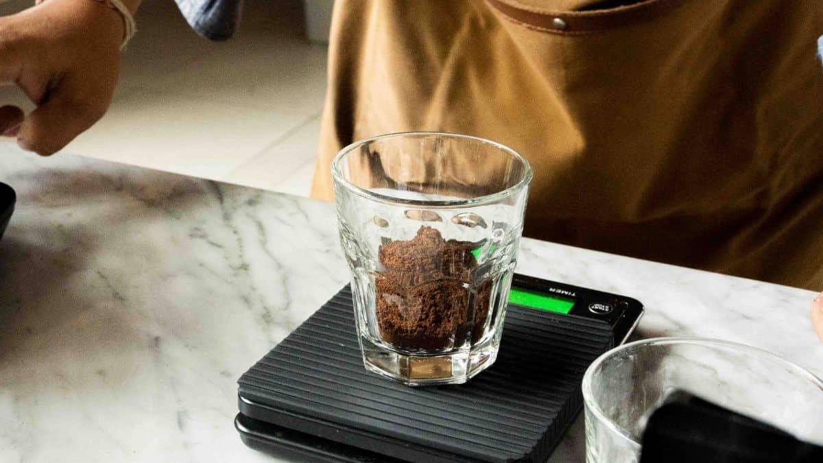 Weighing ground coffee on a digital kitchen scale.