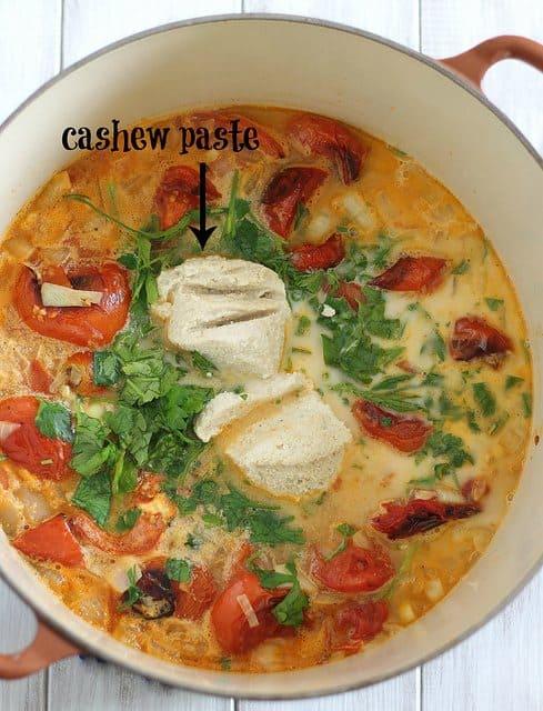 Panera tomato soup in a stockpot with cashew paste.