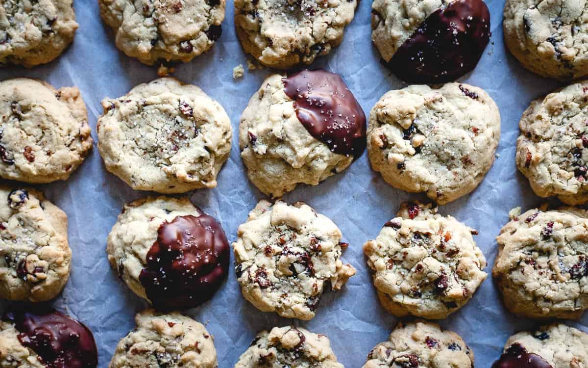 Buttery with the perfect crumble, these cranberry chocolate chip cookies are infused with orange zest and filled with chopped almonds, up to you whether or not they get a chocolate dip!