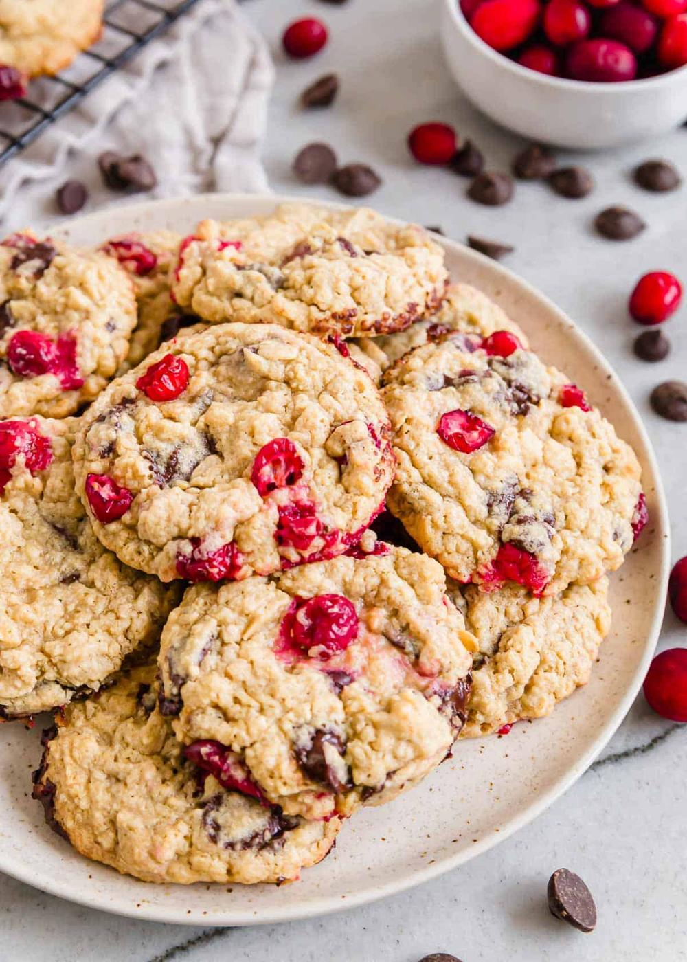 Cranberry oatmeal cookies on a plate with chocolate chips.