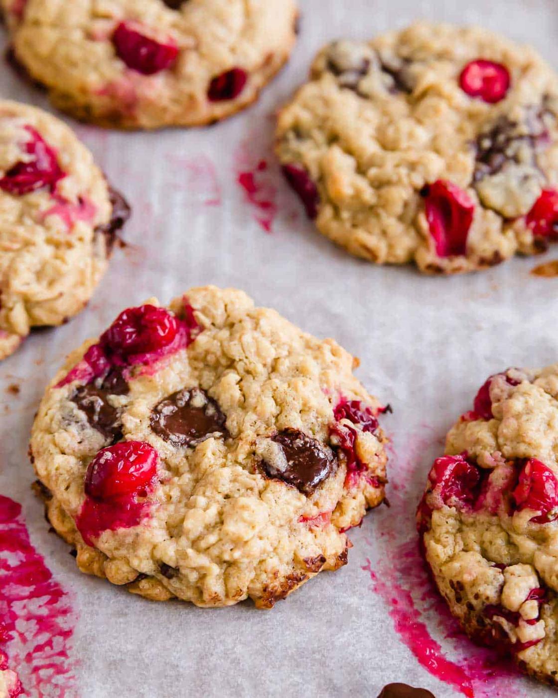 Close up of a cranberry chocolate chip cookie on a baking sheet.