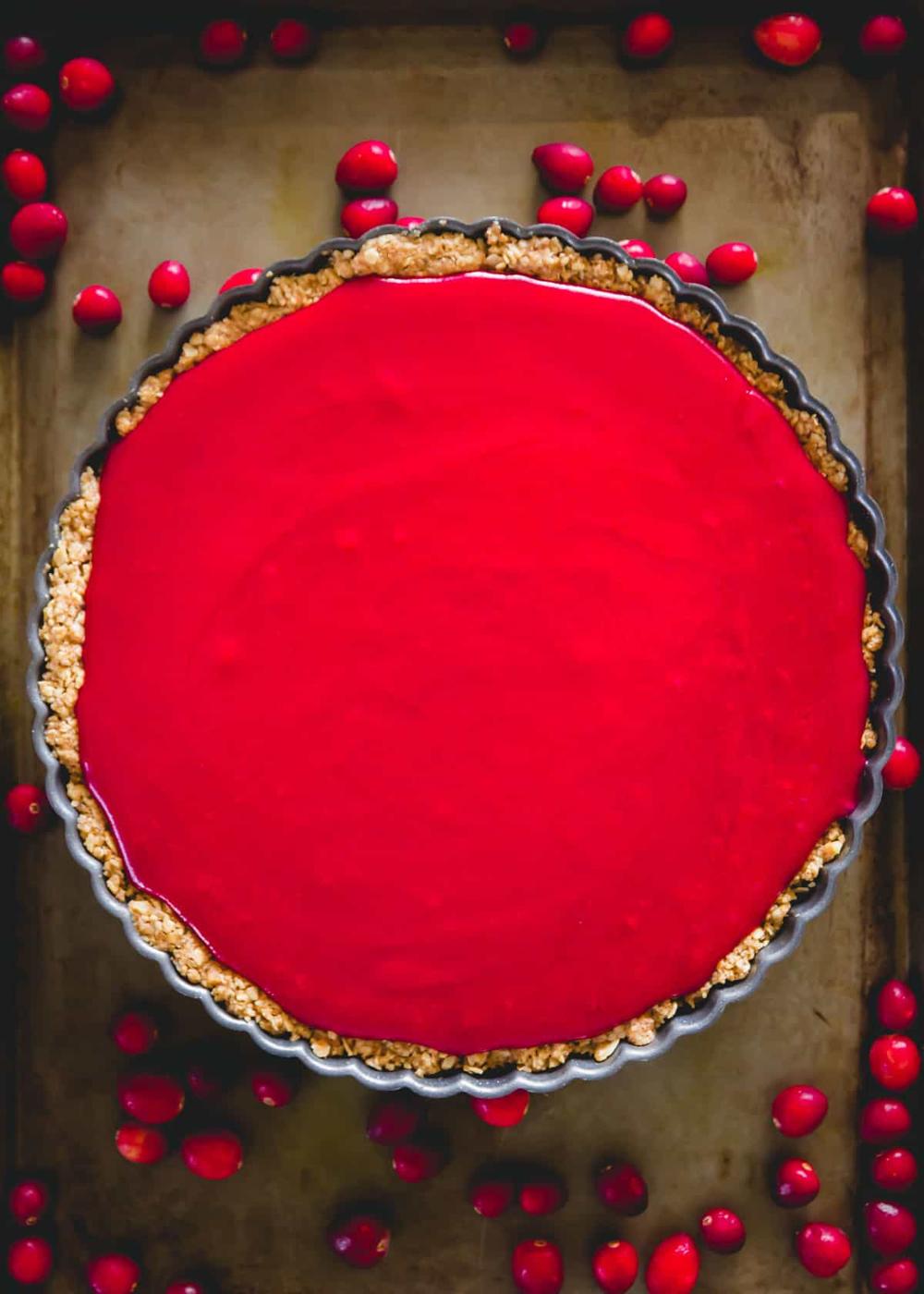 Easy cranberry curd tart with oat and walnut tart crust before setting.