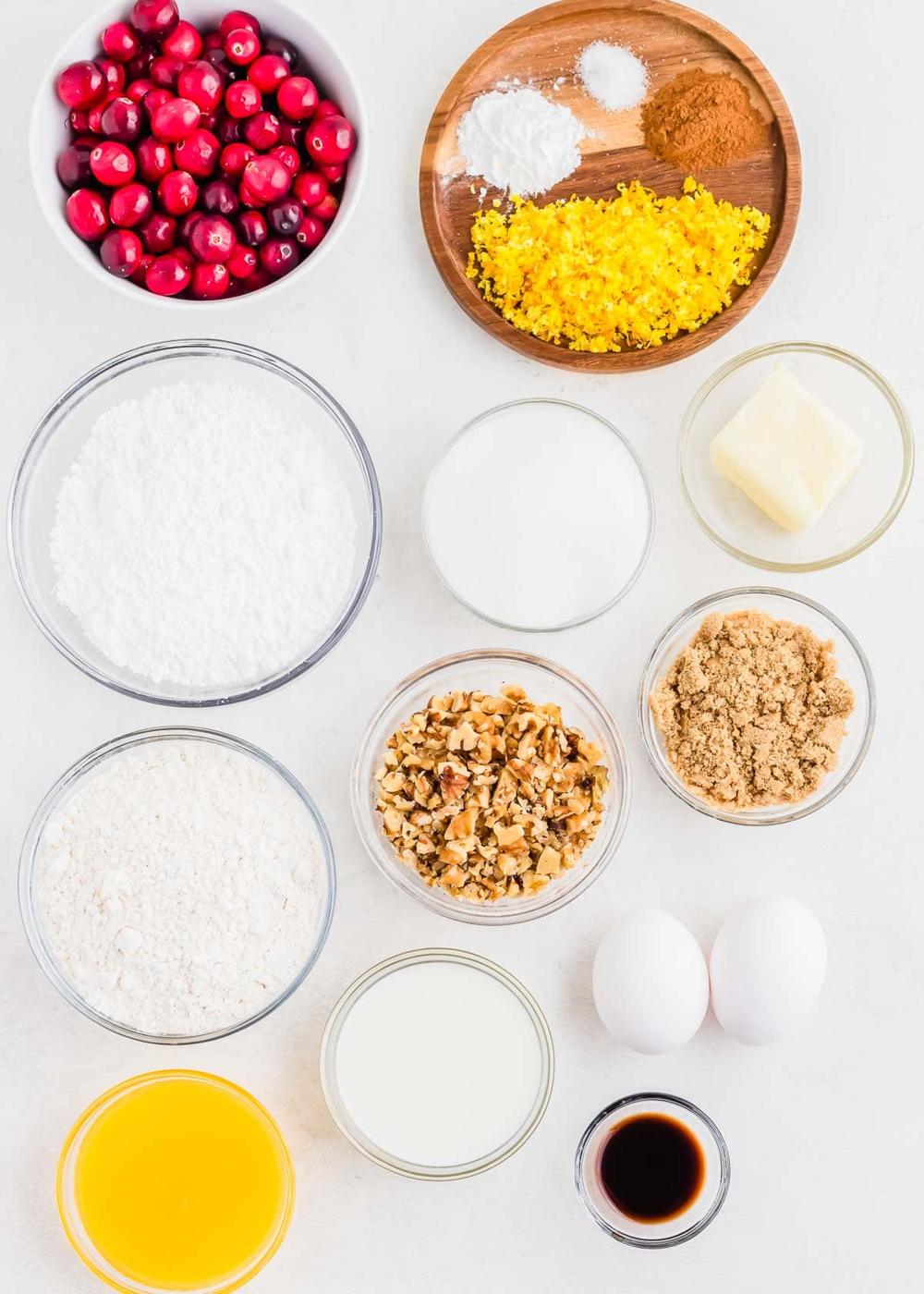 Ingredients to make cranberry orange bread with walnuts.
