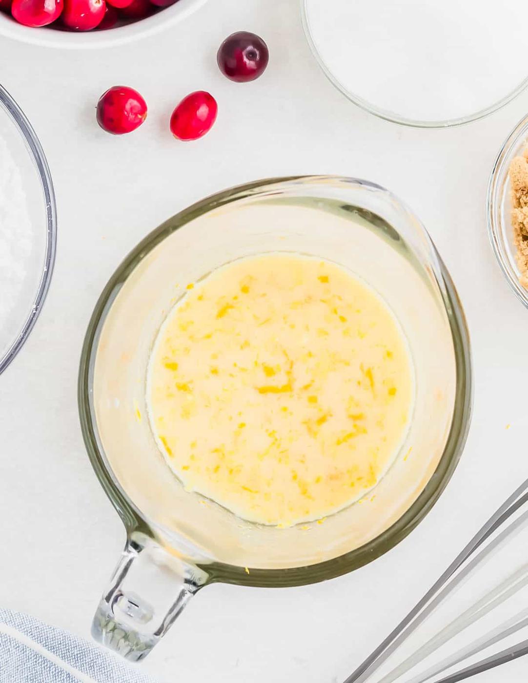 Wet ingredients mixed together in a glass measuring cup.