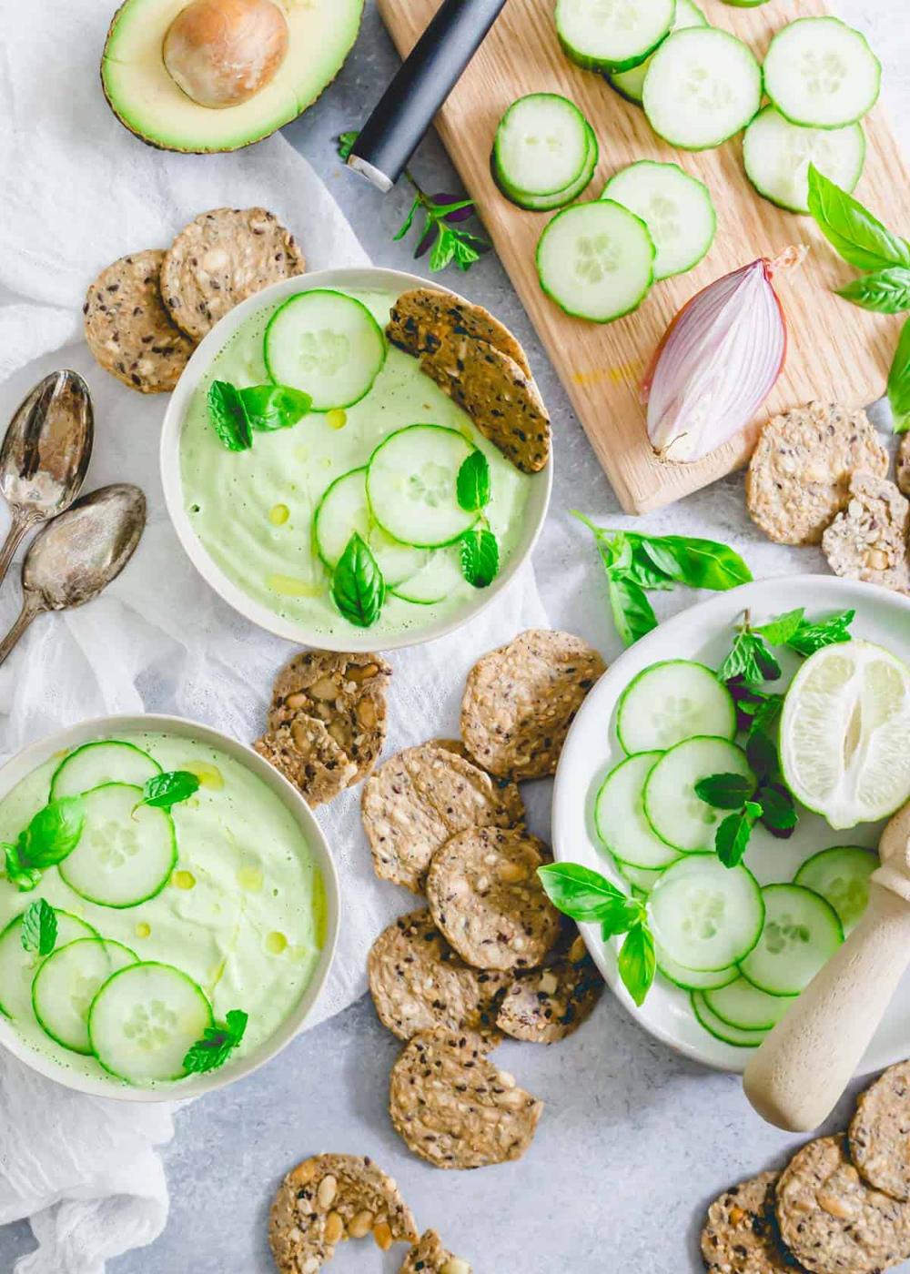 Raw cucumber gazpacho recipe served with gluten-free crackers and fresh herbs.
