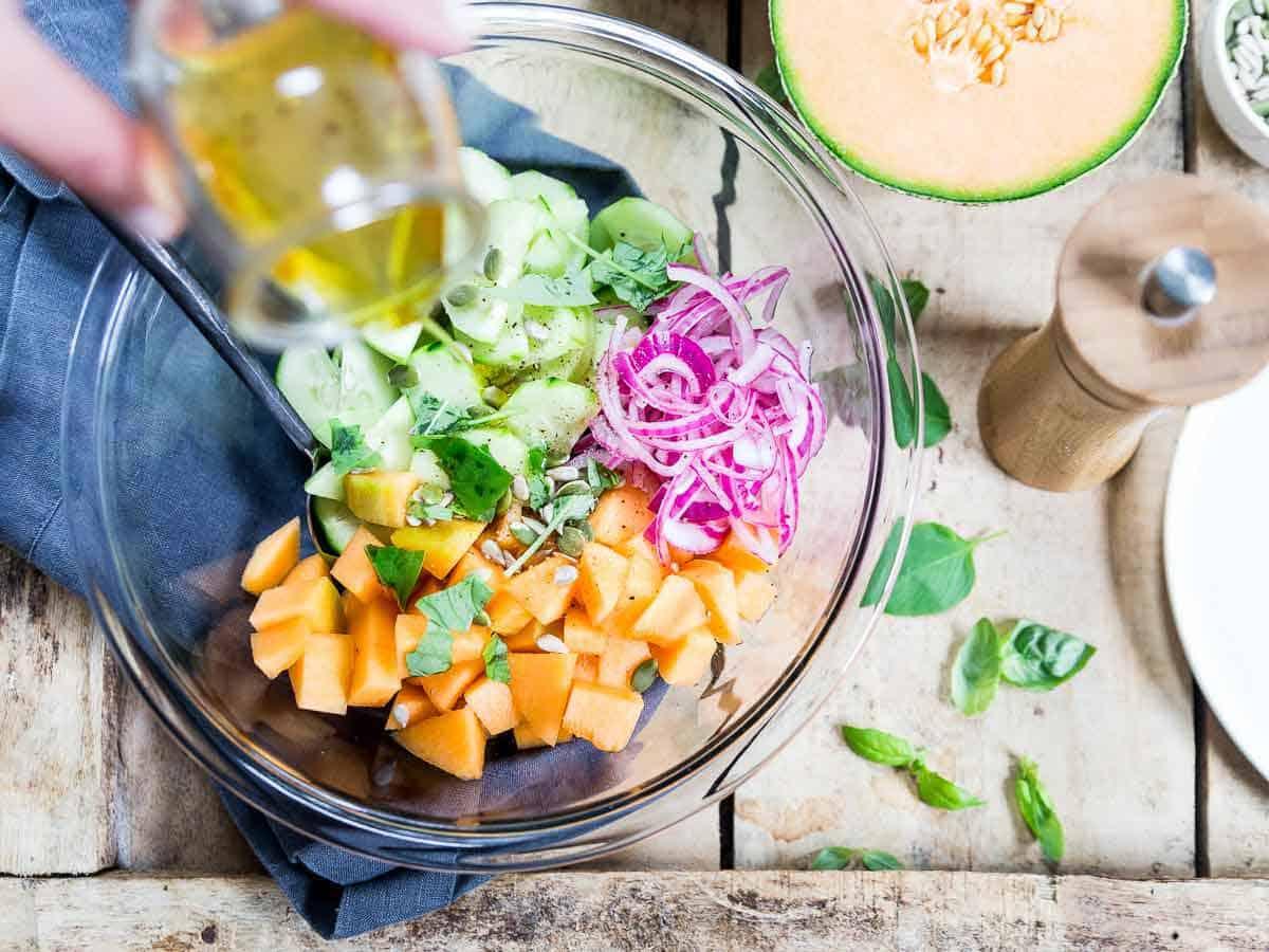 This summer cucumber salad uses sweet cantaloupe and pickled red onions, a refreshing addition to any grilled meal!
