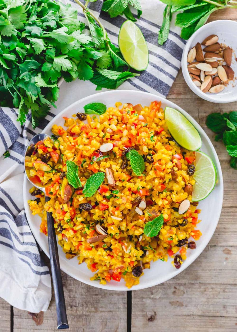 Curry cauliflower rice on a plate with serving spoon.