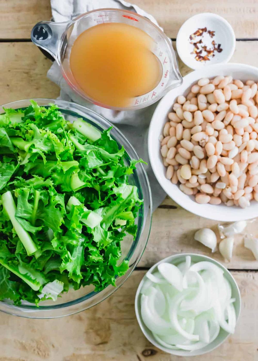 Ingredients to make the Italian dish of escarole and white beans.
