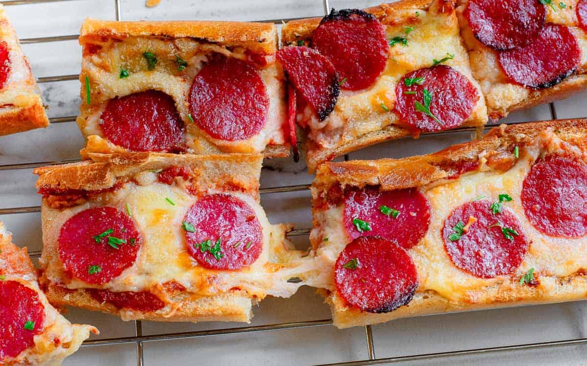 Garlic pizza bread slices on a cooling rack.