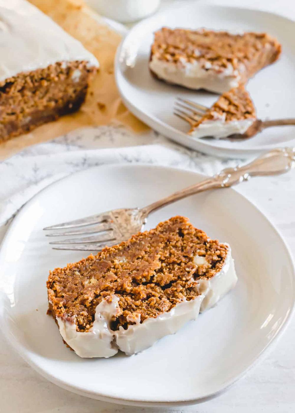 A slice of gingerbread banana bread loaf on a plate with a fork.